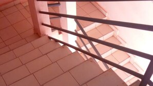 A staircase with a metal handrail and tiled floor. - Makindu Diamond Hotel (Makindu)