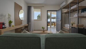 A modern, well-lit room with a large bed, a desk with a computer, a mirror, and a wardrobe. - Casa Panorama Adults Only (Sithonia)