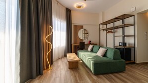 A modern living room with a green sofa, wooden coffee table, and a bookshelf. - Casa Panorama Adults Only (Sithonia)