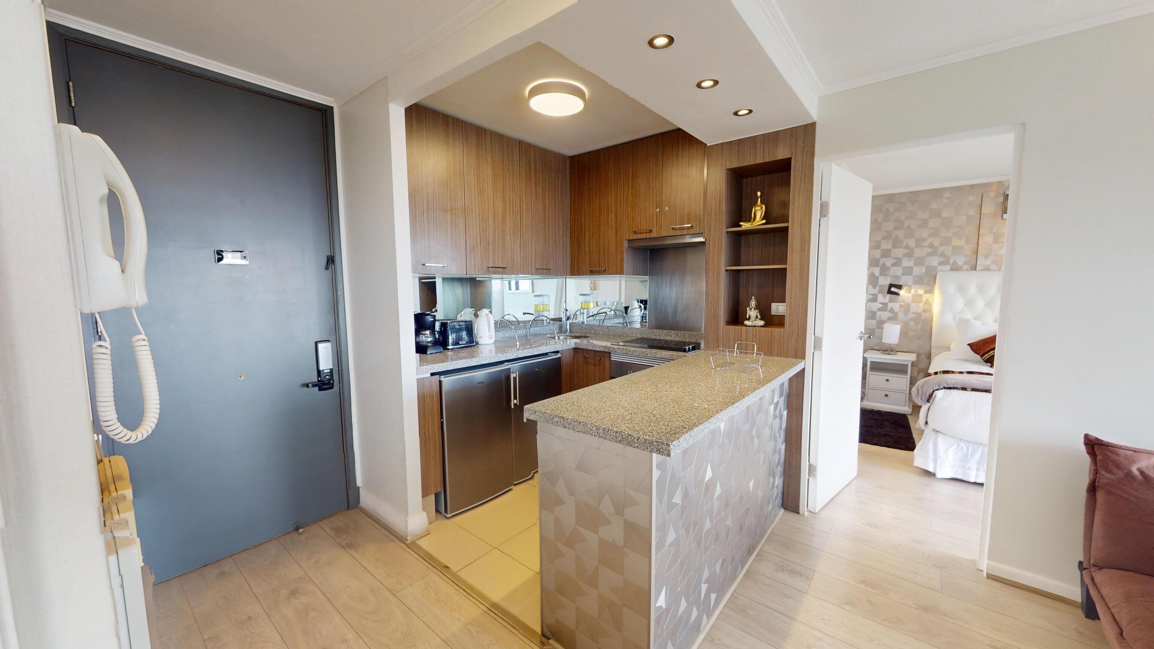 A modern kitchen with wooden cabinets, a built-in island, and a separate dining area.