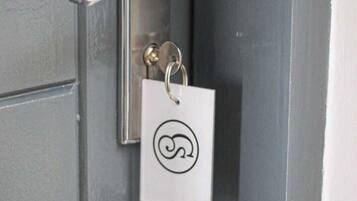 A door with a keyhole and a keyring with a key.