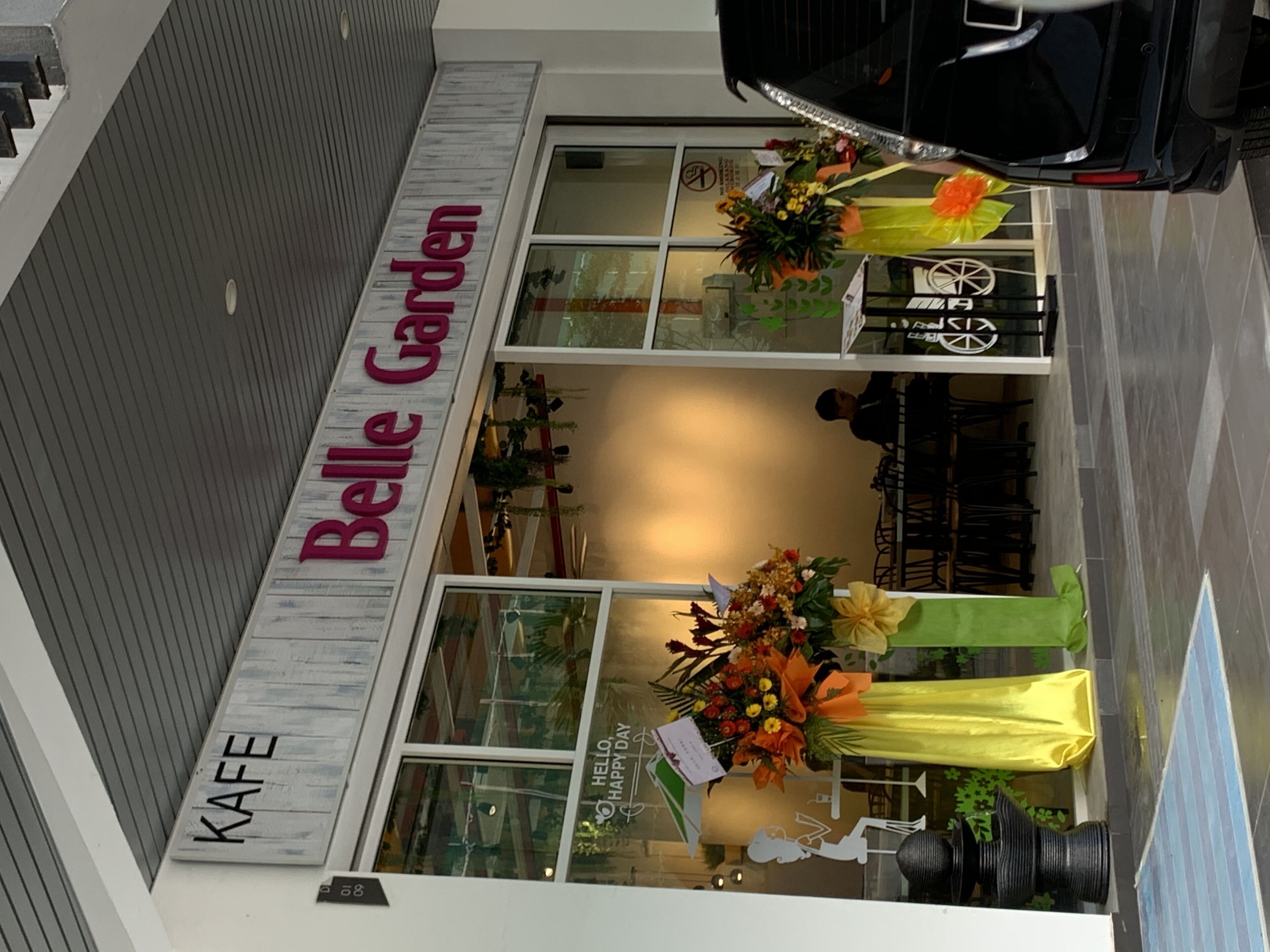 A storefront with a sign reading "Belle Garden" and "KAFE".