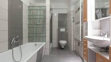 Separate bathtub and shower, towels