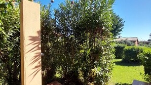Ein Garten mit einem Wasserspiel, einem gefliesten Weg und üppiger Bepflanzung.