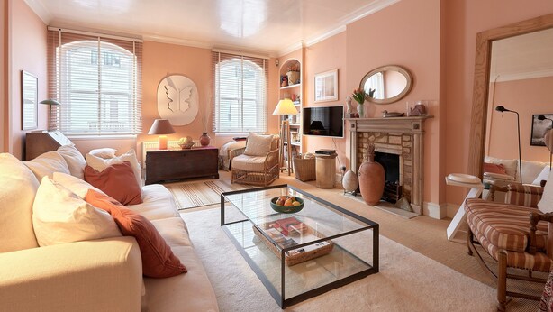 A living room with a sofa, armchairs, a coffee table, a fireplace, and a television. - A PERFECT TREASURE -  KNIGHTSBRIDGE LUXURY MEWS APARTMENT (London)