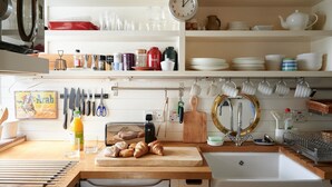 A kitchen with a wooden countertop, a sink, and various kitchen utensils and appliances. - A PERFECT TREASURE -  KNIGHTSBRIDGE LUXURY MEWS APARTMENT (London)