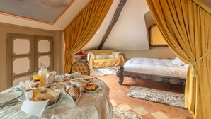 A room with a bed, a dining table with breakfast, and a window with curtains. - Live the high life in Lake Como in a period villa with lake view & private pool (Menaggio)