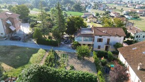 A residential area with houses, a road, and a grassy area. - Vacation House Rita in green Umbria (Gubbio)