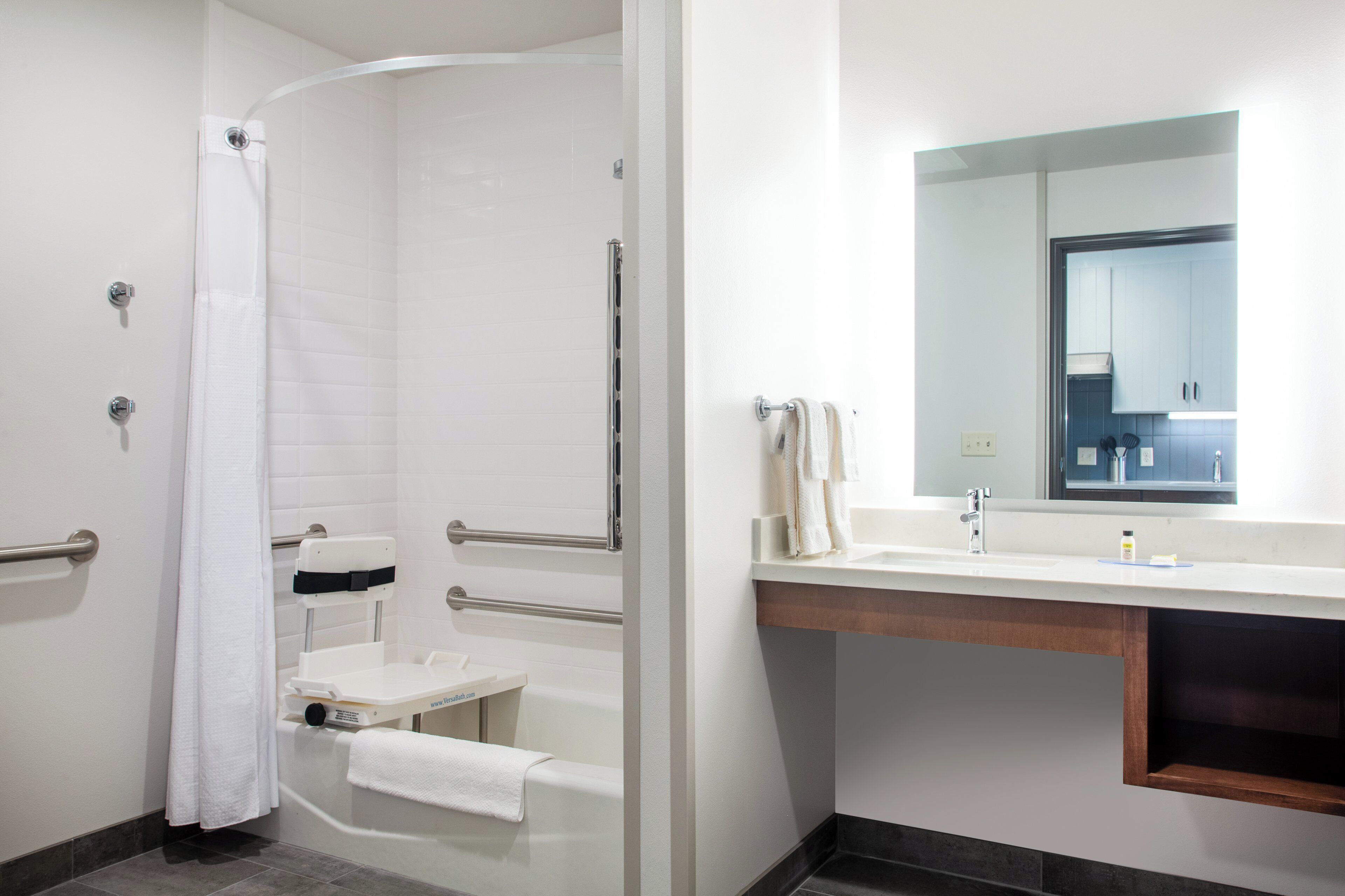 A bathroom with a shower, toilet, and sink.