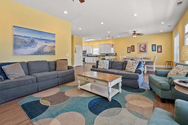 A living room with a gray sofa, a coffee table, and a colorful rug.