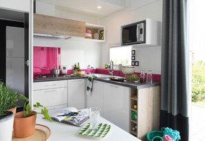 Enjoy cooking in this well-equipped kitchen with a microwave, gas stove, and island with sink and countertop.