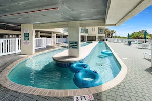 A pool area with a no diving sign, a no glass in pool area sign, and a no eating or drinking in pool sign. - Large oceanfront family-sized condo rental w/lazy river, pool, and fitness center near Ocean Drive (North Myrtle Beach)
