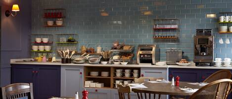 Un restaurant avec un mur recouvert de carreaux bleus, des tables et des chaises en bois.