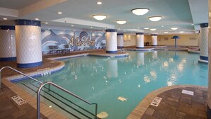A large indoor swimming pool with a mural of dolphins and the text "MarVista Grande." - Luxe oceanfront resort with pools, lazy river, hot tubs, spa, fitness center, poolside bar (North Myrtle Beach)