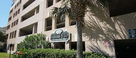 A multi-story building with a sign for Beachwalk Villas at 4108 North Ocean Blvd.