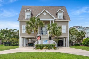 Stunning two-story residence with a central entrance, gabled roof, and a charming porch.