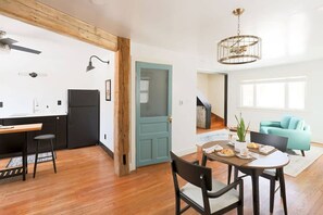 Relax in this stylish living space with a dining area, kitchenette, and comfortable sofa.