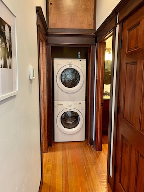 Convenient laundry facilities with two front-loading washing machines.