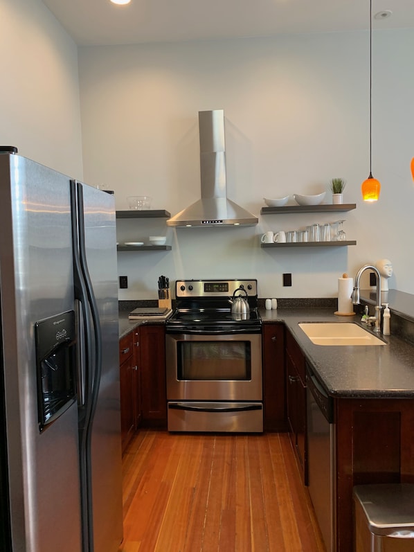 Enjoy cooking in this well-equipped kitchen with a refrigerator, oven, and gas stove.