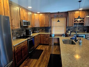 Fridge, microwave, oven, stovetop - Relax by Lake of the Ozarks in your spacious Sunrise Beach retreat on 1 acre. (Sunrise Beach)
