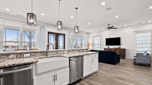 A modern kitchen with granite countertops, stainless steel appliances, and pendant lighting. - Luxe boulevard home w/private pool, elevator, outdoor kitchen-purely wonderful! (North Myrtle Beach)