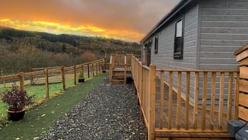 Step out onto the deck and take in the serene forest views from this cozy cabin.