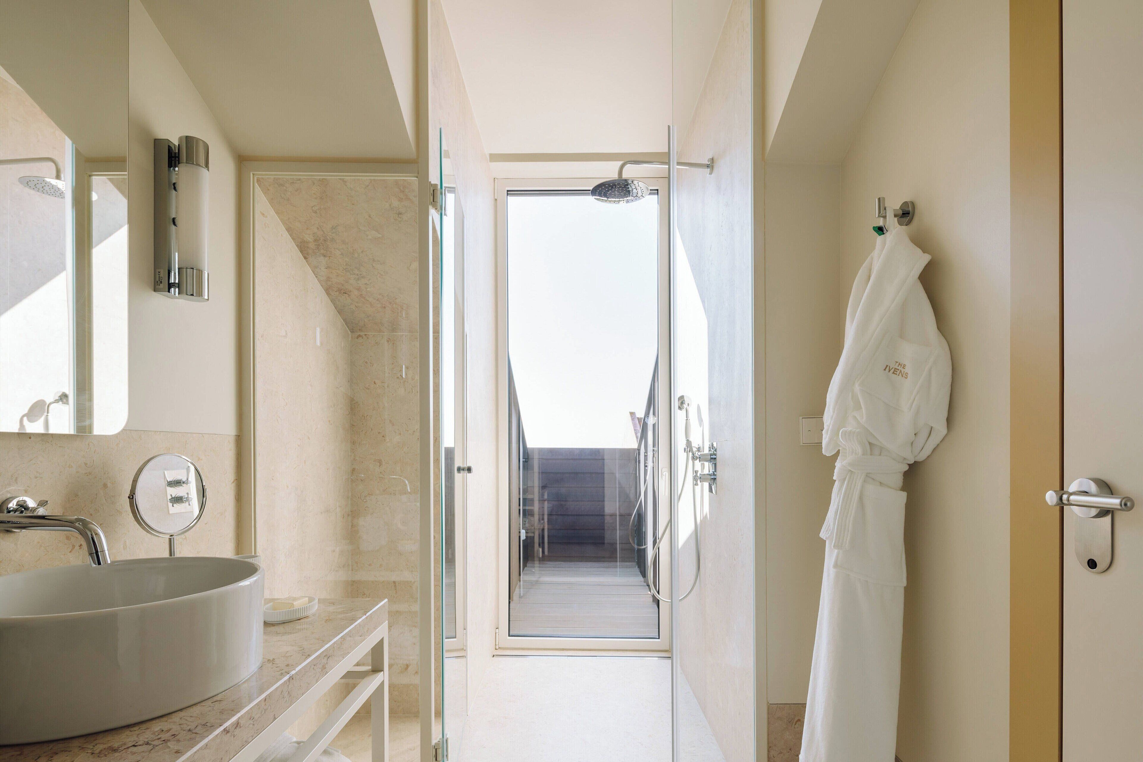 signature suite, 1 king bed, non smoking, balcony | bathroom | hair dryer, slippers, towels, soap