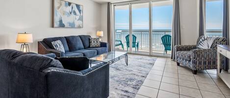 Sectional seating and sliding doors framing the ocean at Crescent Shores 706 in Crescent Beach