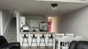 A modern apartment with a dining area, kitchen, and a staircase leading to an upper floor. - 4BR/3BA Lakefront Penthouse, Clearwater Condominiums<br>Sleeps 8 (Camdenton)