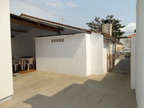 Simple, functional home with a garage and outdoor seating area.