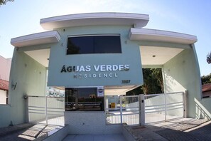 En modern byggnad med en skylt som visar texten ”ÁGJAS VERDES RESIDENCE”.