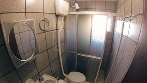 Ein kleines Badezimmer mit Toilette, Waschbecken und Duschkabine.
