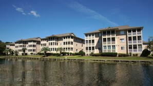 A multi-story hotel with balconies, a swimming pool, and well-maintained landscaping.