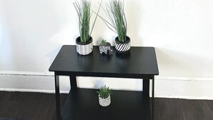 A black table with three potted plants and a small decorative elephant figurine. - Bella's Boutique Hotel (Hemingway)