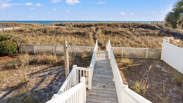 A wooden boardwalk leading to a beach with a clear view of the ocean. - Oceanfront, dog-friendly vacation home w/gorgeous ocean views, large deck-steps from beach (North Myrtle Beach)