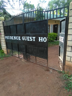 A metal gate with the words "PRUDENCE GUEST HO" indicating a guest house. - Prudence Guest House (Bondo)