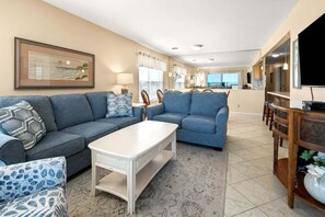 A living room with two sofas, a coffee table, and a TV.