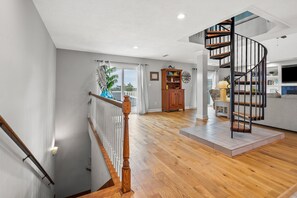 Stunning interior space with a spacious open area, cabinet, and seating area with a table and chairs.