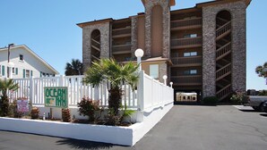 A multi-story building with a brick facade and multiple balconies. - Charming oceanfront condos w/pool, price-friendly in perfect area - North Myrtle Beach rental (North Myrtle Beach)