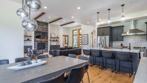 A modern kitchen with a central island, dark cabinetry, and pendant lighting. - Golf View, Hot Tub, Suncadia Pool Access (Cle Elum)