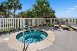 A swimming pool with a deck, lounge chairs, and a white fence. - Oceanfront duplex steps from beach w/shared pool, game room, kids' pool, grill (North Myrtle Beach)