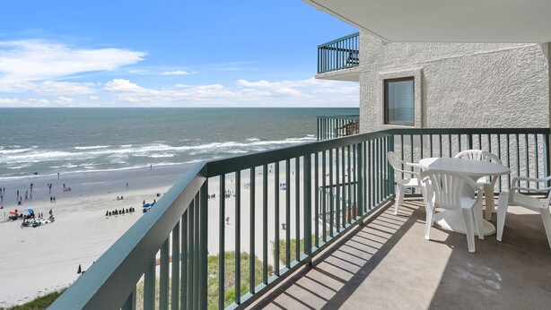 A balcony with a view of the beach and ocean. - Perfect for families or groups looking for an upscale beachfront experience. (North Myrtle Beach)