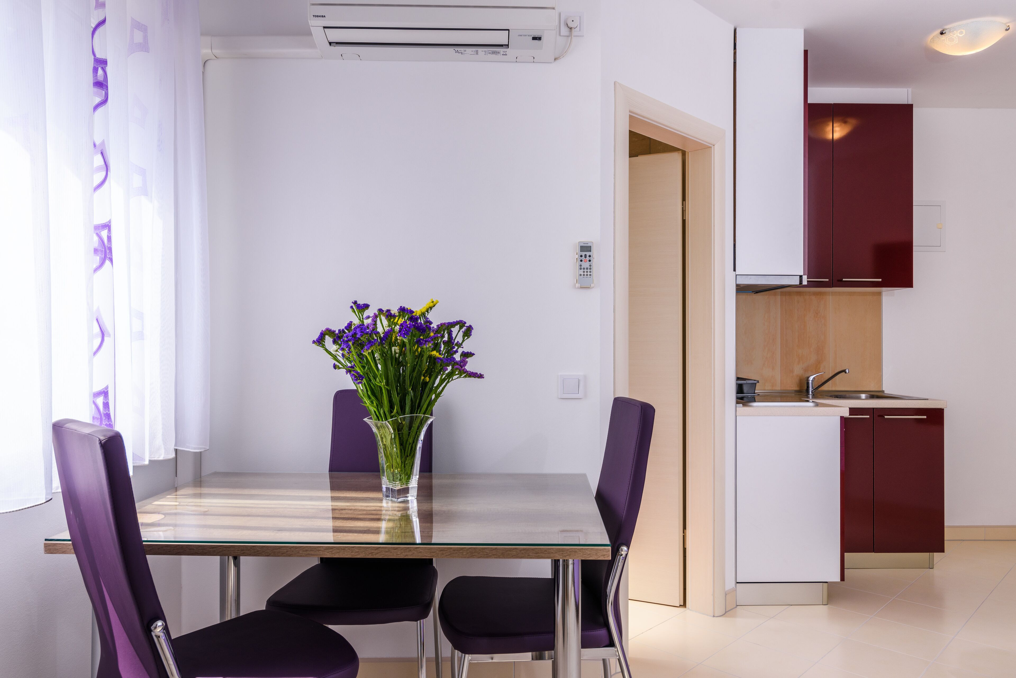 A modern kitchen with a built-in oven, a sink, and a wooden countertop.