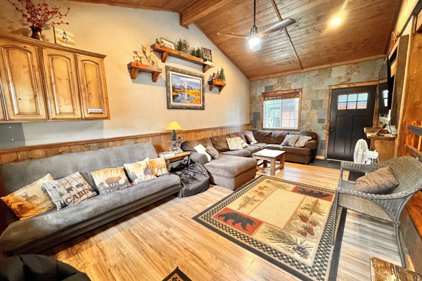 Family Rm, 70’ smart TV, Ceiling fan, wall heat, futon/bedding, open to Kitchen