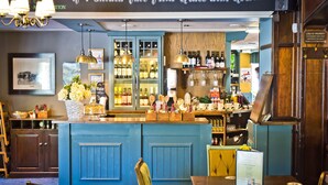 A bar area with a blue counter, shelves with bottles, and a sign above reading "If I should fall from Grace with God...". - Bowling Green (Manchester)