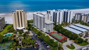 A high-rise hotel complex with multiple buildings, a beach, and a swimming pool. - Gullwing 405 by Distinctive Beach Rentals (Fort Myers Beach)