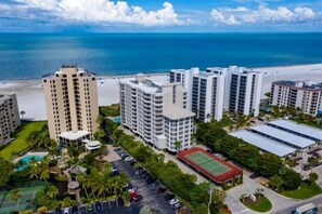 A high-rise hotel complex with multiple buildings, a beach, and a swimming pool. - Gullwing 405 by Distinctive Beach Rentals (Fort Myers Beach)
