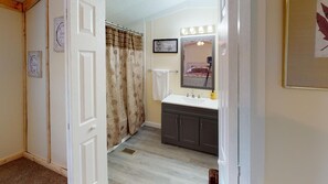 Combined shower/bathtub, towels, toilet paper