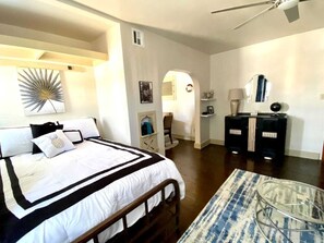 A bedroom with a bed, a desk, a chair, and a lamp. - Evie's apartment (Oklahoma City)