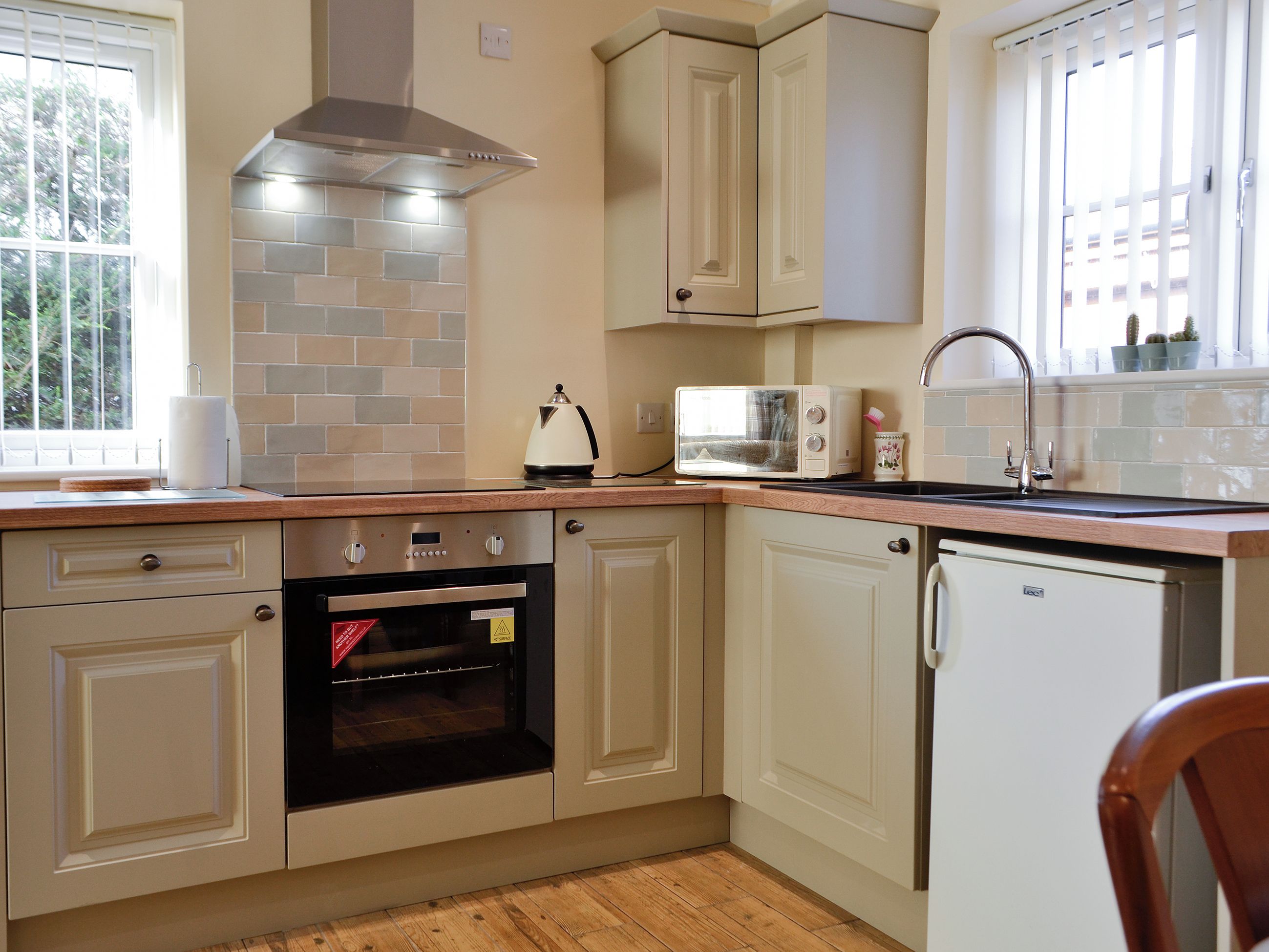 A kitchen with a built-in oven, a microwave, and a dishwasher.